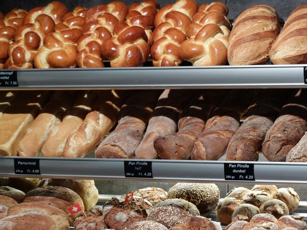 A bakery display case filled with fresh pastries and bread