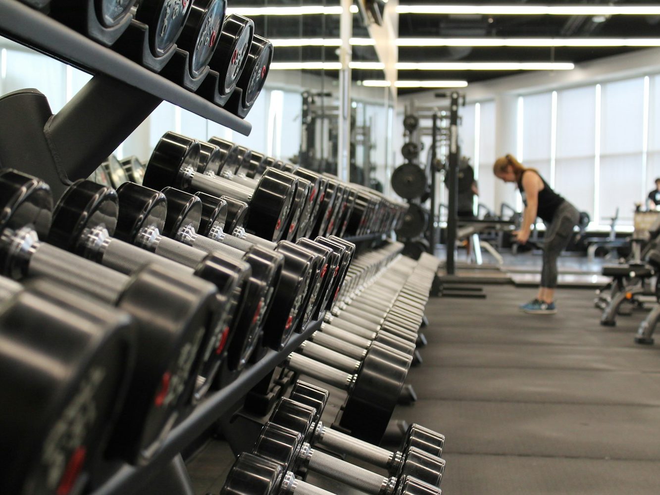 A gym floor with a rack of dumbbells ready for training