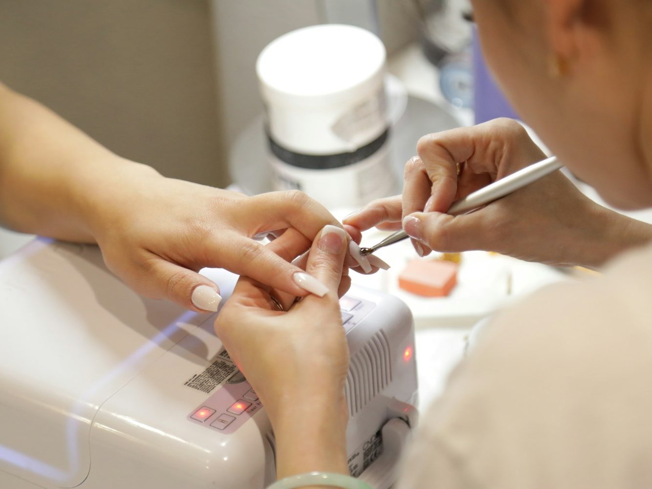 A manicure in progress at a nail studio