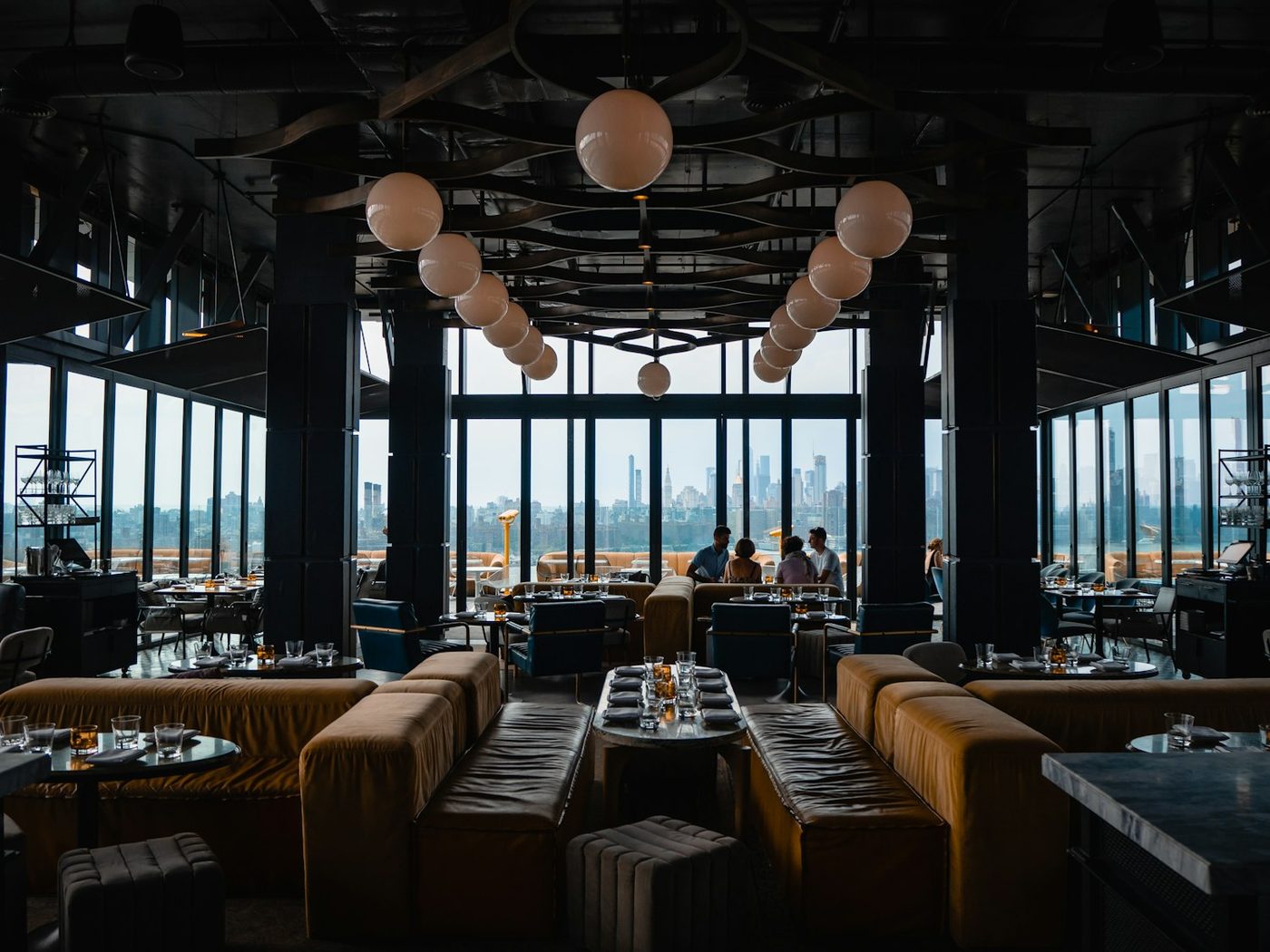 A warm restaurant dining room set for evening service